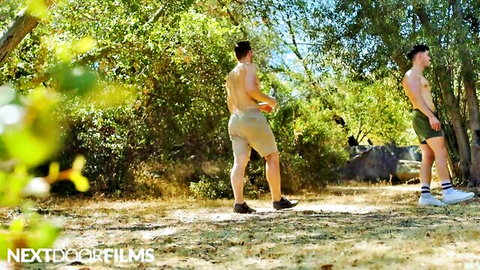 Brandon Anderson and muscular friend in shorts outdoors, shirtless athletic bodies