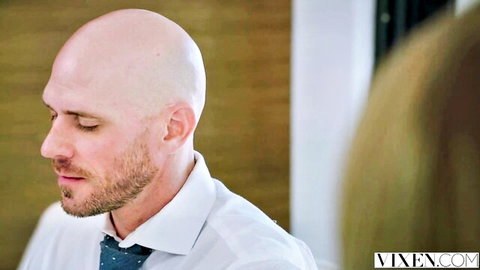 Mia Melano with bald, bearded stud in suited Vixen scene
