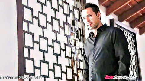 Handsome man in unbuttoned black shirt smoking cigarette against lattice screen