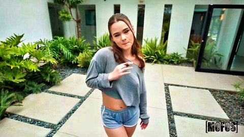 Skinny brunette teen teases small tits in off-shoulder crop top and tiny denim shorts outdoors
