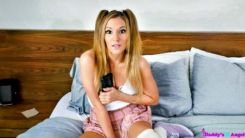 Moka Mora in schoolgirl outfit with pigtails, teasing on bed