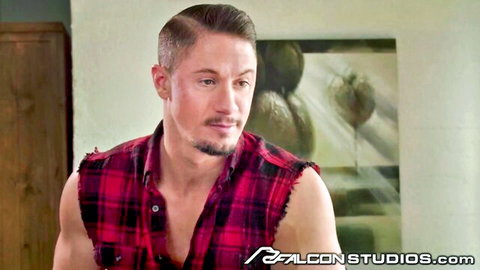 Muscular athletic gay stud with goatee smirks in ripped plaid shirt exposing ripped chest