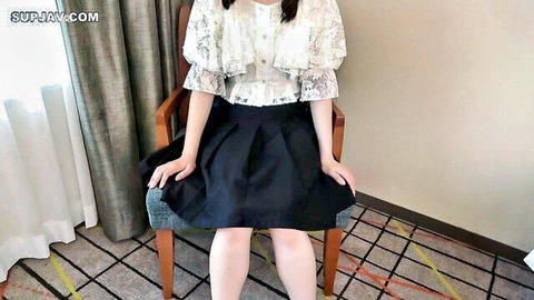 19-year-old skinny Asian girl in sheer top and blue skirt sits teasingly