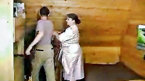 Fat Russian granny in shiny silver robe with man in amateur setup