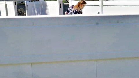 Alex Blake in plaid shirt leaning over railing in naughty work break tease