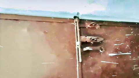 Rusty metal door with lock in Akash Arya's homemade Indian threesome scene