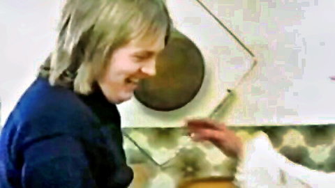 Vintage blonde smiling in kitchen, teasing with big natural tits