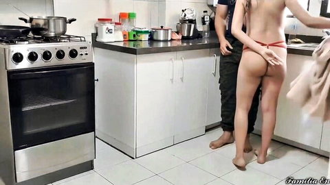 Stepdad gropes busty stepdaughter's ass in thong while wife cooks