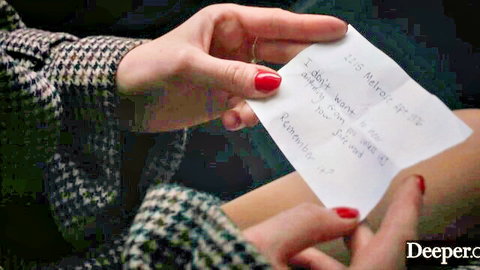 Fair-skinned hands with red nails holding handwritten note 'I just want deeper' in steamy porn tease