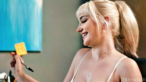 Blonde trans babe with huge tits smiling in thin top holding sticky note and pen