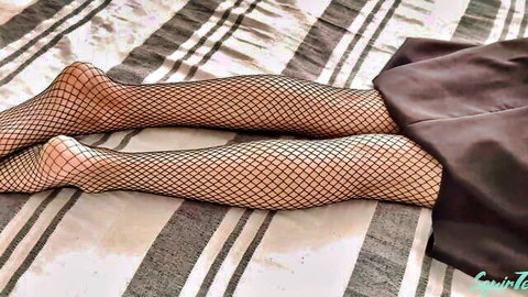 Step-sister's sexy legs in fishnet stockings on striped bed