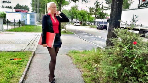 Blonde Daynia in sexy office attire, mini skirt and stockings, outdoor tease