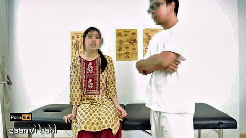 Young Indian babe in yellow salwar kameez sits on exam table with doctor in white coat