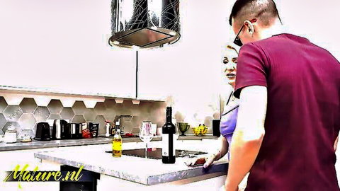Blonde woman smiling seductively at young man in purple shirt by kitchen counter