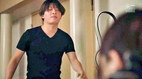 Japanese man in black V-neck shirt spreads arms intensely toward long-haired woman in hallway