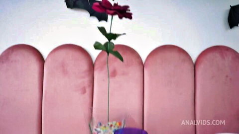 Pink velvet tufted headboard with Halloween rose and bats for anal sex setup