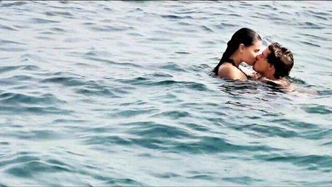 Victoria Blaze passionately kissing man in ocean waves at boat party