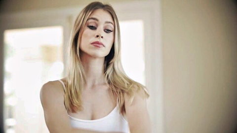Sultry young blonde in tight white tank top teasing small tits with pouty lips