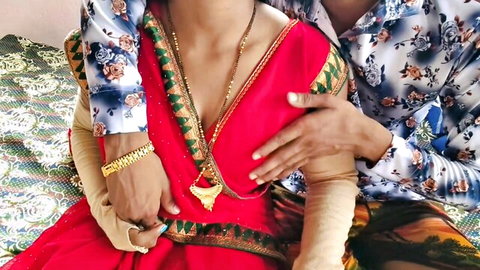 Desisarika Indian aunty in red saree passionately embraced by young stud