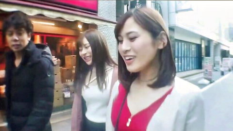 Lucky guy walking with two smiling Asian women on street before hotel fun
