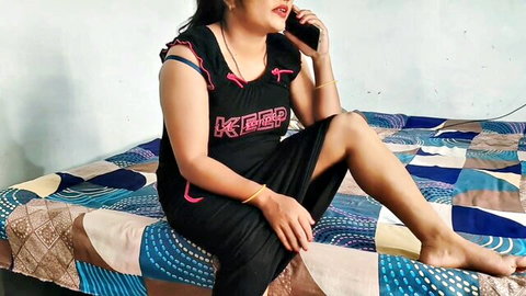 Desi bhabhi in sexy black nightgown talks on phone, teasing pose