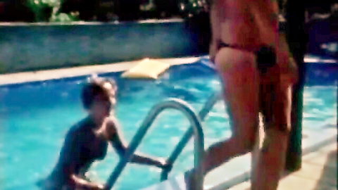 Vintage lesbian poolside tease with two women in skimpy bikinis