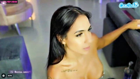 Latina cam girl Anna Sec teasing massive cleavage in low-cut top