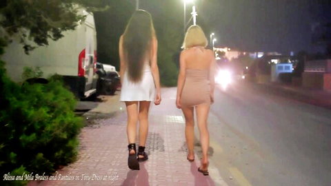 Mila braless in white mini dress and Alissa pantiless in beige, night street walk