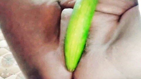 Brown hand inserting thick green cucumber deep into stretched wet Indian pussy