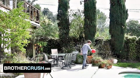 Zach Brenton bends over with red ball in backyard, teasing twink in gay brother scene