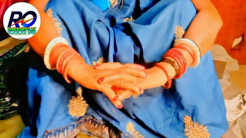 Desi woman in blue saree with red bangles, clasped hands teasing