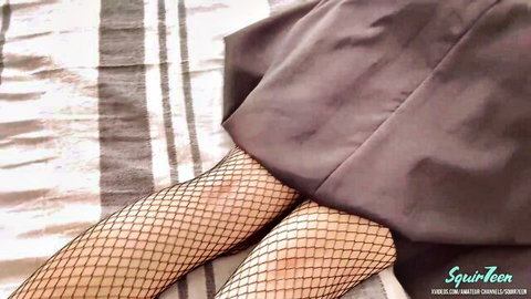 Teen in fishnet stockings spreads legs teasing tight pussy under skirt