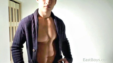 Muscular Asian hunk posing shirtless in open purple sweater revealing ripped abs and chest