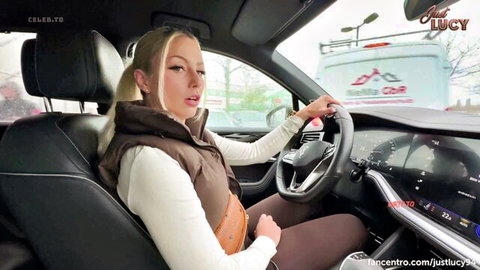 Blonde babe Just Lucy grips steering wheel with open mouth in public Tesla car tease