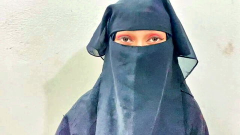 Niqab veiled woman with kohl-lined seductive eyes staring intensely