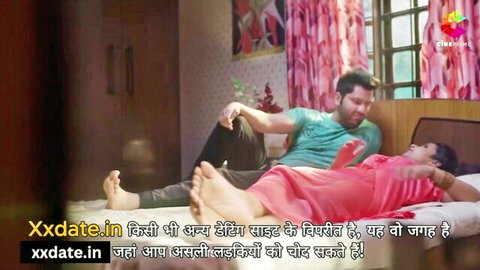 Yorgelis Carrillo in pink dress spooned by man on bed