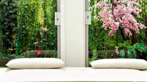 Angie Faith's serene bedroom with garden view in NVG casting