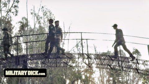 Silhouetted military cadets in uniforms on bridge for wild anal orgy