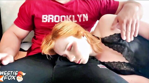 Seductive redhead in black lace lingerie lying with eyes closed, ready for action