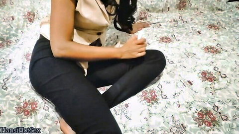 Sultry Sinhalese girl in beige vest and tight black pants sitting seductively