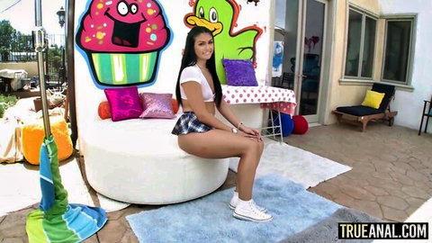 Kylie Sinner in short plaid skirt and crop top, teasing outdoors