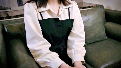 Sexy Japanese babe in sheer blouse and black apron top teasing big tits on green couch