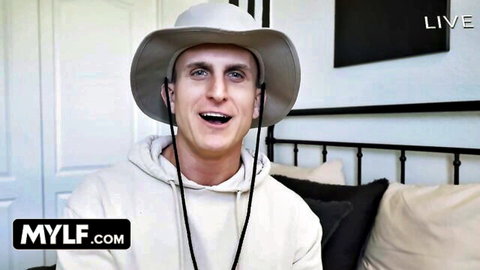 Smiling cowboy hat man in white hoodie on MYLF live bedroom stream