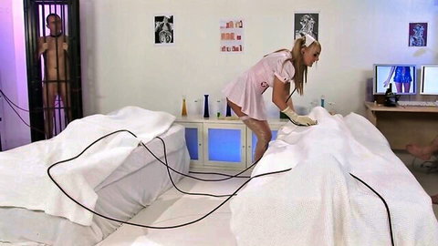 Kinky ebony maid in pink outfit bends over in BDSM scene with caged man