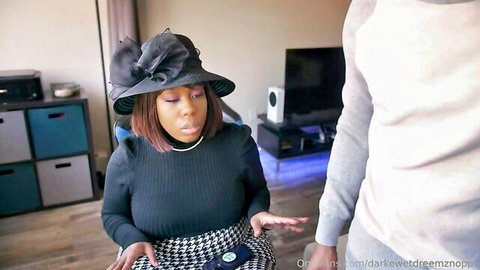 Gorgeous black BBW in stylish hat and outfit sitting with partner in amateur clip