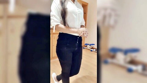 Sexy Indian woman in sheer white blouse showing cleavage and tight black pants posing seductively