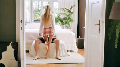 Nancy A in white blouse and plaid skirt, reverse cowgirl on man