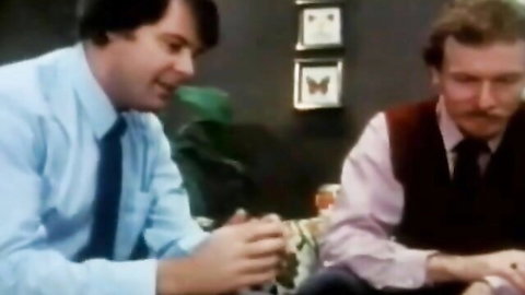 Vintage XXX thumbnail of two suited men sitting and chatting intimately