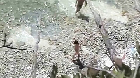 Nude skinny couple walking on beach in outdoor splendor