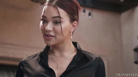 Leana Lovings seductive close-up in black blouse, red hair and green eyes